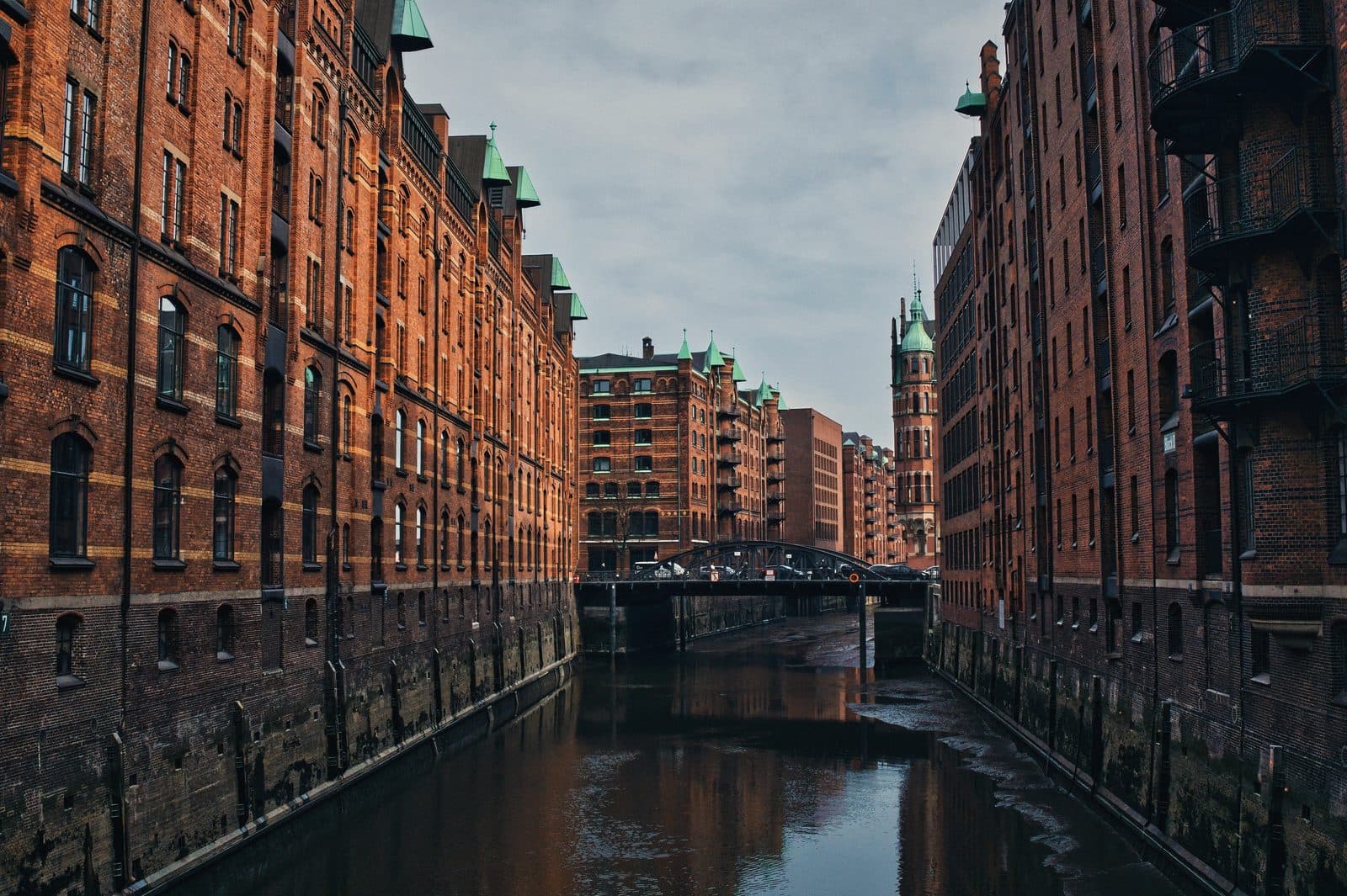 A canal between the brick warehouses of Hamburg's Speicherstadt